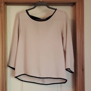 Cream 3/4 length blouse with bow detail in the back and black seam lining